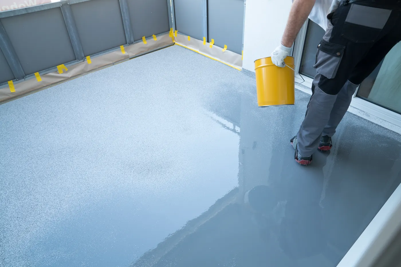 Waterproof coating being applied to a concrete floor