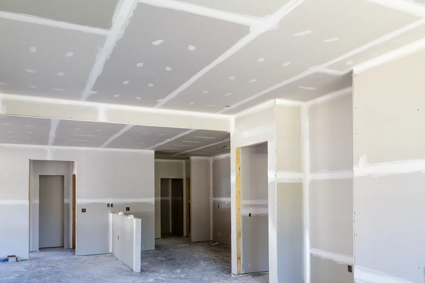 New drywall finished in an open-plan room during a remodel